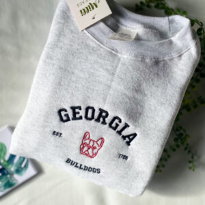Embroidered University of Georgia with red bulldogs on the ash color sweatshirt and The monstera coaster with Millithreads on the side.