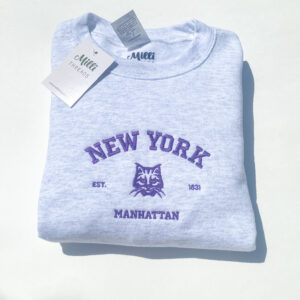 Embroidered New York University Manhattan with a bobcat in ash color sweatshirt.