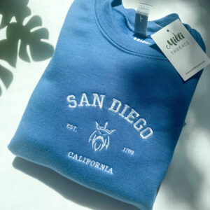 Denim blue color sweatshirt with a white King Triron embroidered and San Diego California text.