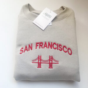 Embroidered San Francisco California sweatshirt in a sand color sweatshirt. vintage Golden Gate bridge-style crewneck with red threads.