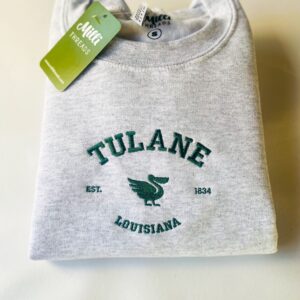 Embroidered Tulane Louisiana sweatshirt in an ash color sweatshirt. Vintage Tulane University-style crewneck with the forest green pelican.